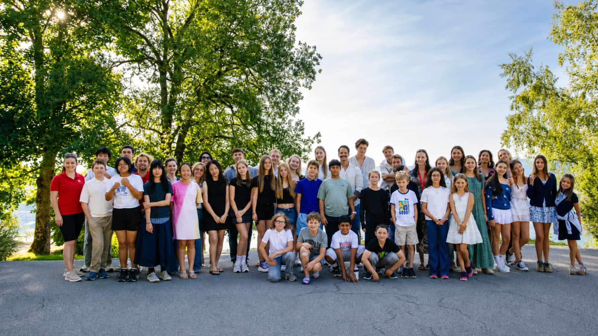 Large diverse group of students and teachers outdoors at World Schools.
