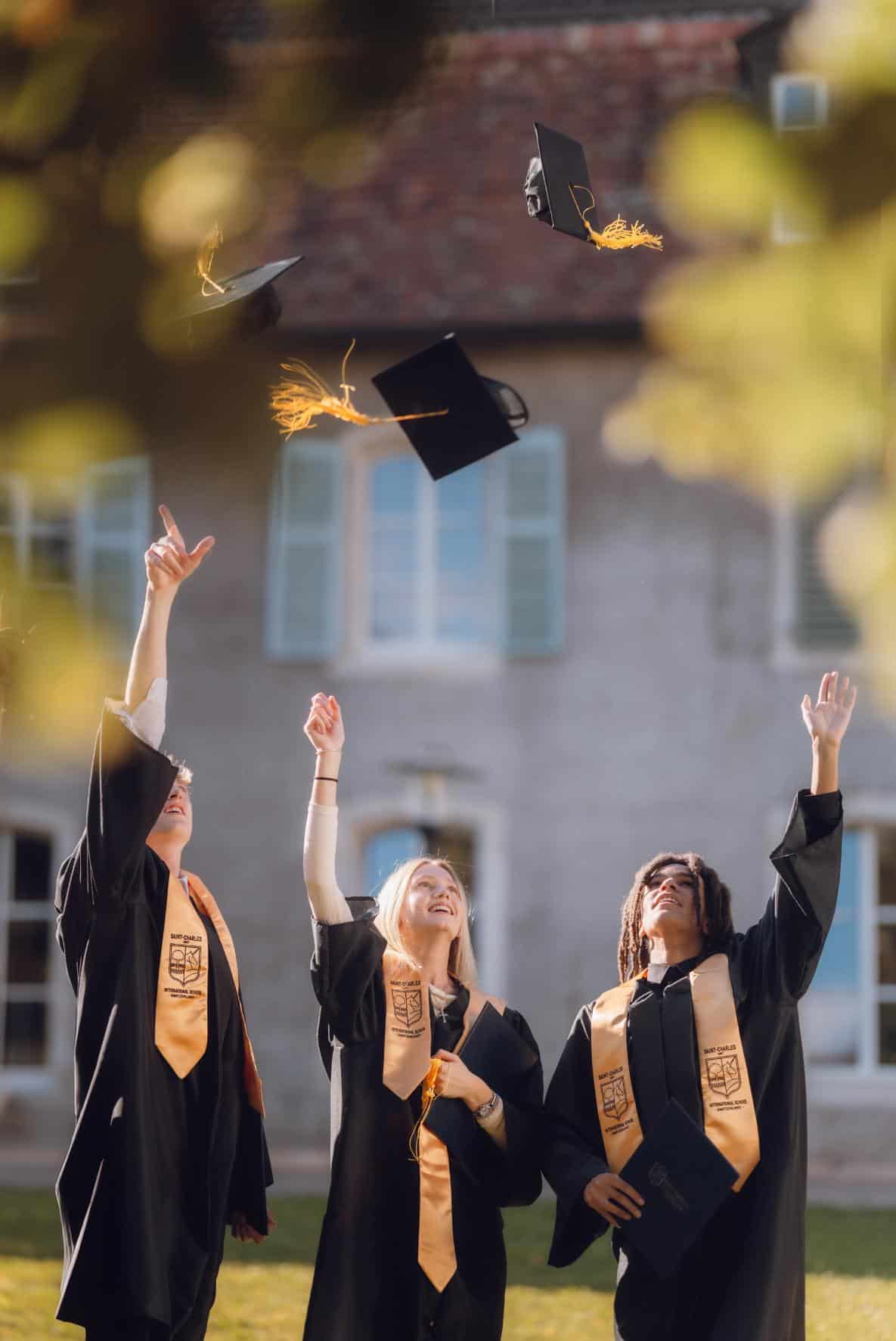 Graduates tossing caps during the World Schools graduation ceremony.