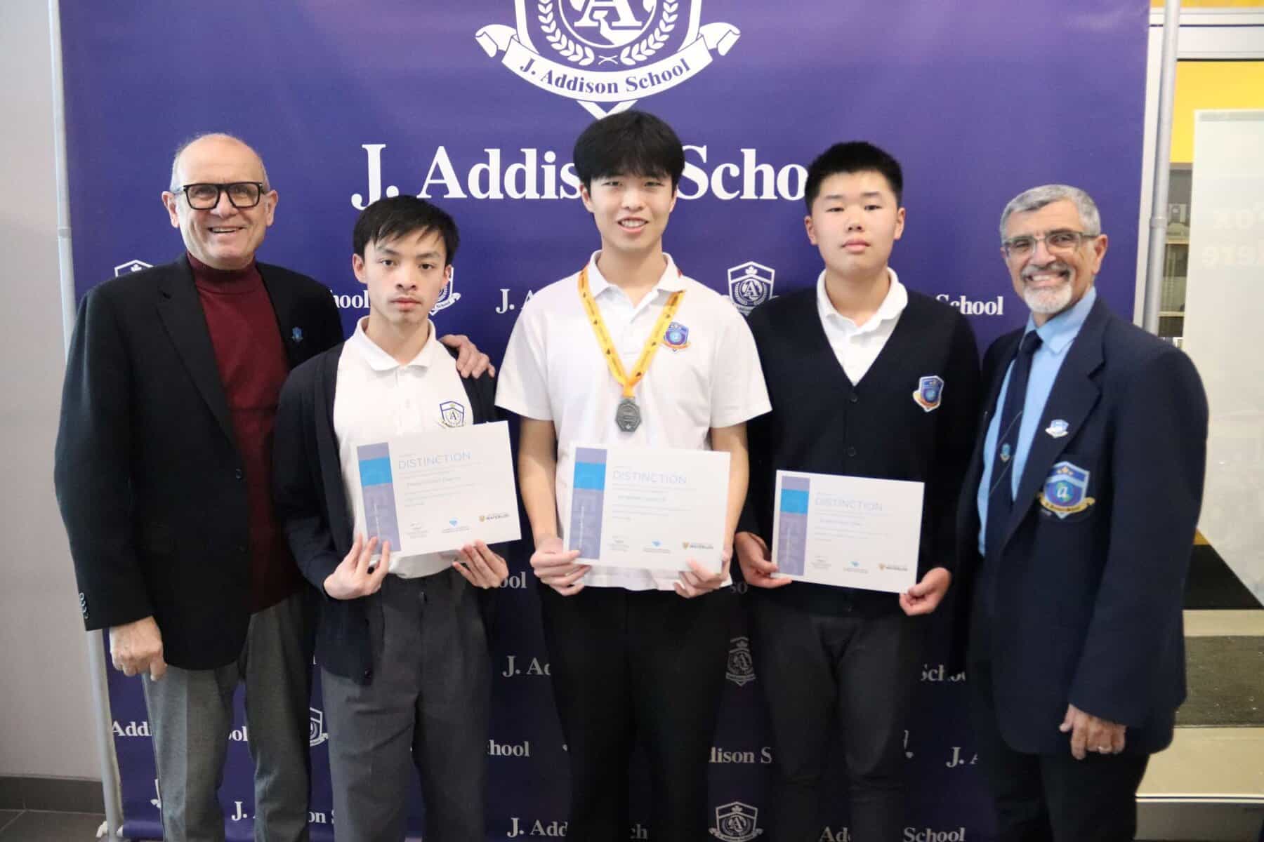 Young students receiving academic awards at J. Addison School.