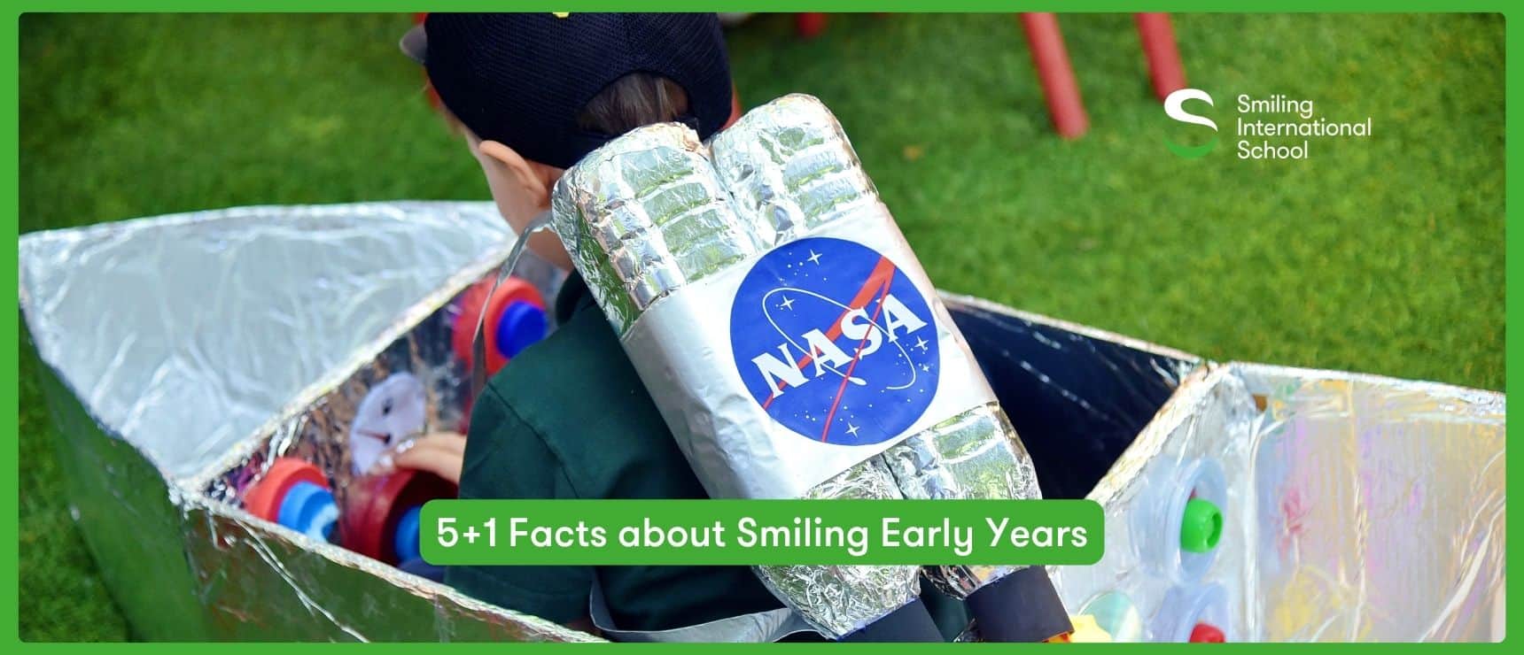 Children engaging in space-themed activity with NASA rocket model outdoors.